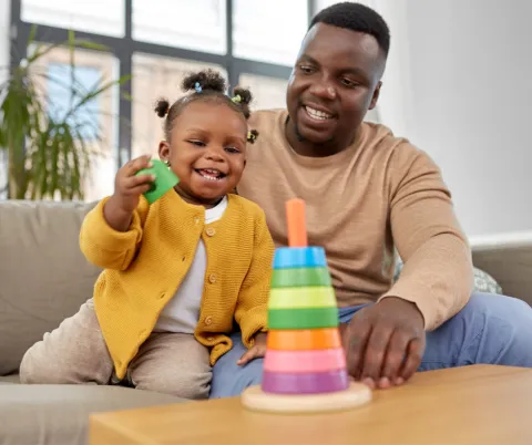 adult and toddler playing together
