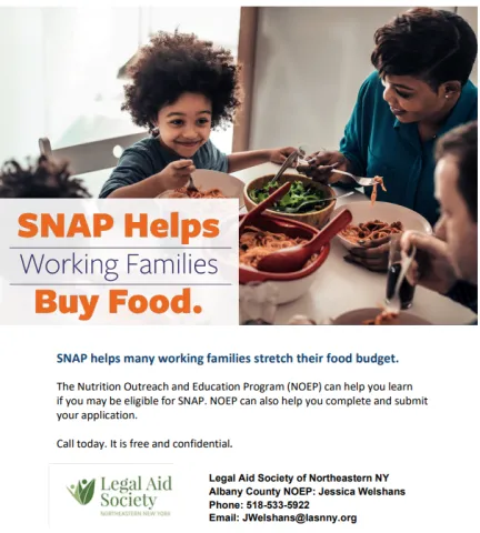 child seated at dinner table with adult